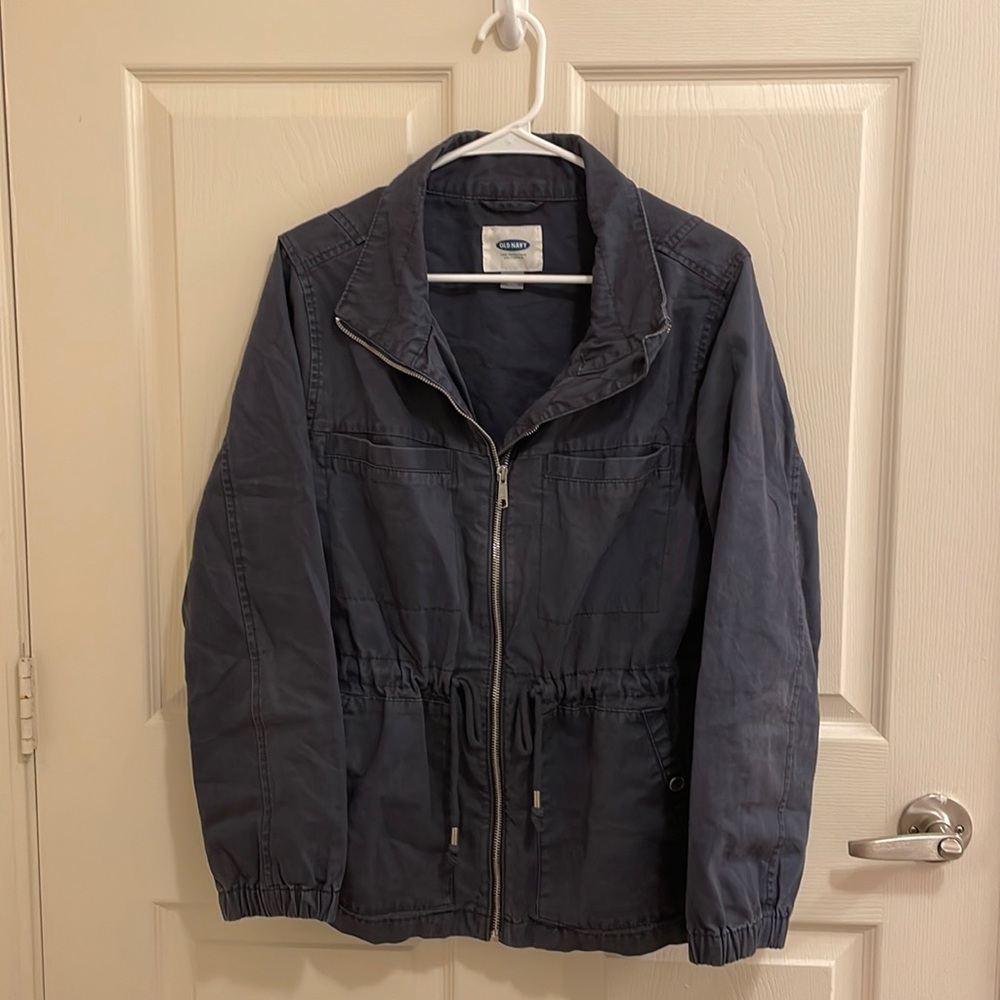 Navy blue collared zip up jacket with a tie around the waist